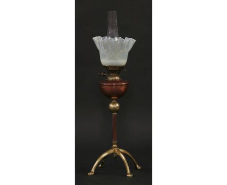 A Benson brass oil lamp,with four curved legs, reeded column and copper reservoir, inscribed 'WAS Benson &amp; Co. Ltd., Lond