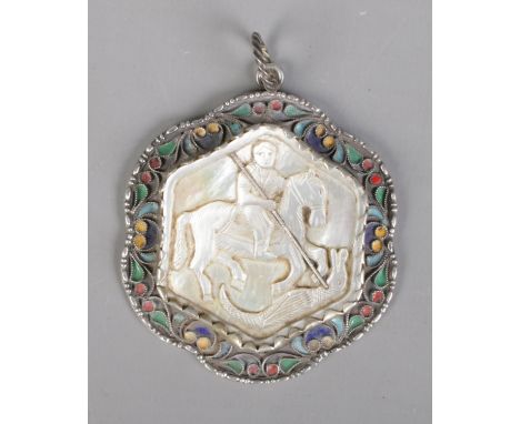 A 19th century Russian silver pendant. With central carved mother of pearl panel depicting a warrior on horse back and enamel