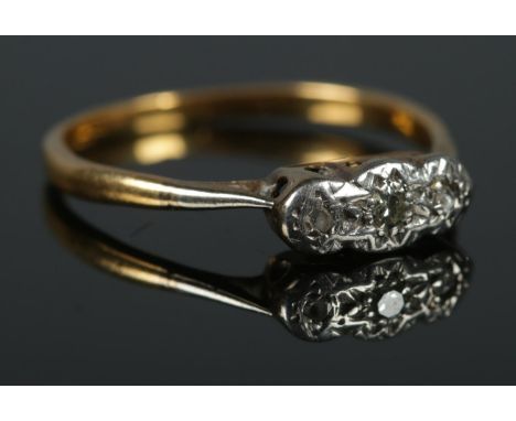 An 18ct Gold and Platinum illusion set three stone diamond ring. Size LÂ½. Total weight: 1.7g.  