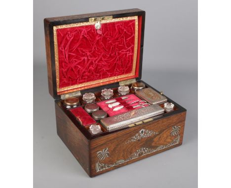 A Victorian rosewood vanity box and contents. Having mother of pearl inlay, fitted interior and side compartment.  Appears co