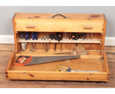 A hinged pine tool case, with contents of tools. To include saws, mallet, drill bits, files etc.  