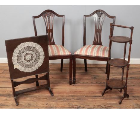 A pair of mahogany dining chairs along with a folding cake stand and metamorphic table/fire screen.  