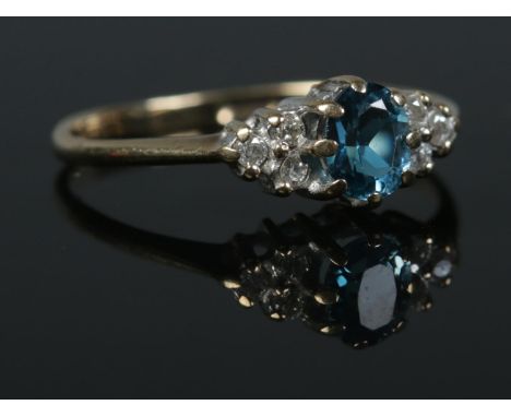 A 9ct Gold 'London Blue' topaz and diamond ring, size JÂ½. Total weight: 1.2g  Slight scratches to central stone.