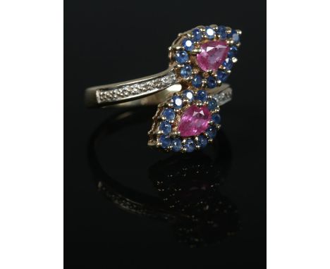 A 9ct Gold sapphire, ruby and diamond crossover dress ring. Size NÂ½. Total weight: 4.7g  