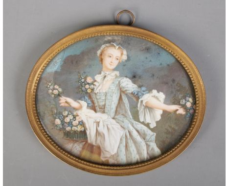 A 19th century gilt framed painted ivory miniature, portrait of a flower girl. Bearing Latin excerpt to back of picture, Sili