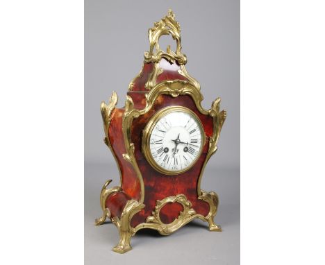 A 19th century French Japy Frere's eight day red tortoiseshell mantel clock with ormolu mounts. Having Roman and Arabic numer