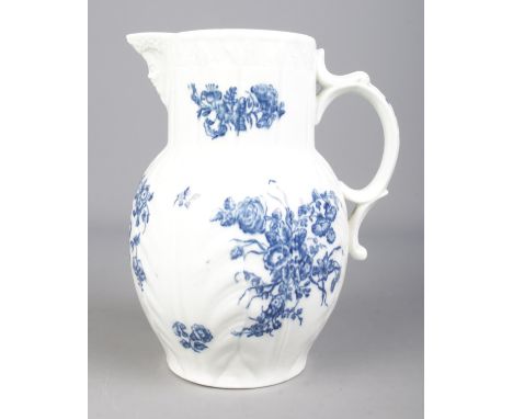 A Worcester cabbage leaf jug with Bacchus mask, scrolled handle and transfer printed floral sprays. Height 23.5m.  