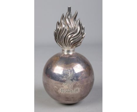 An Edwardian silver military grenade table lighter bearing the Brinkley family coat of arms to one side and a rearing dragon 