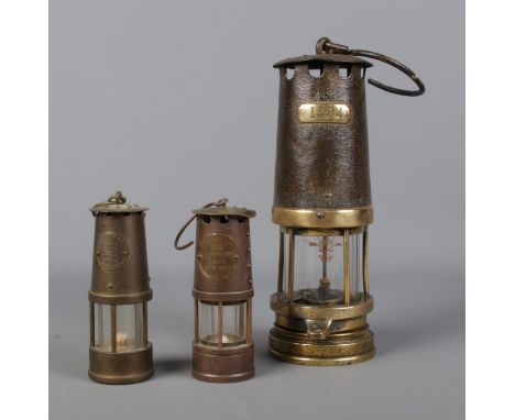 A small Protector Lamp &amp; Lighting Company miners lamp along with two other stamped 1292 and Sir Humphry Davy.  