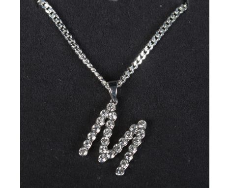 A silver 'letter M' pendant set with clear coloured stones on silver chain. In Georg Jensen box.  