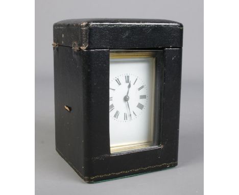 A French brass carriage clock with leather and glass travel case. Having Roman numeral markers and chiming on a coiled gong. 