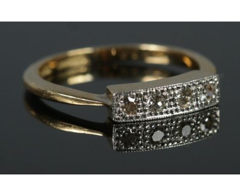 An 18ct Gold and Platinum four stone Diamond ring, in illusion set border. Size J. Total weight: 2.4g  