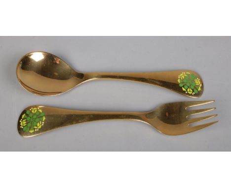 A silver gilt fork and spoon set by Georg Jensen, with matching enamel floral decoration to each terminal. Dated 1989 and bea