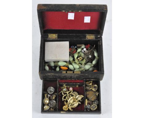 A vintage jewellery box containing a selection of costume jewellery, including earrings and brooches