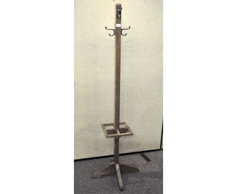 A 20th century vintage oak hall stand, with hooks atop and umbrella/stick storage beneath, 173cm high