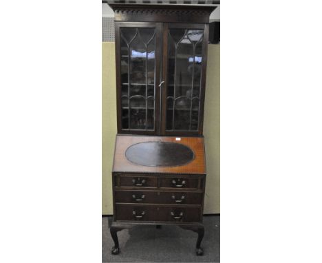 A 20th century reproduction mahogany bureau bookcase, astragal glazed doors, fall front door over two short and two long draw