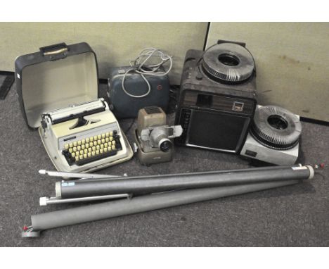A collection of assorted items, including an Aldis projector, other projectors, screens, a typewriter and more