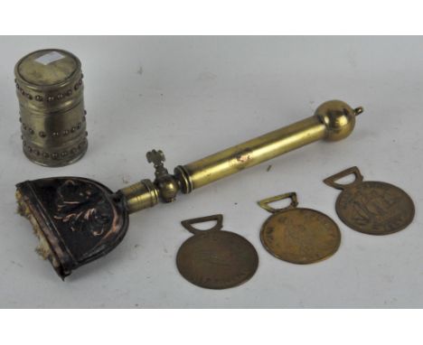 A brass trench art lighter, in the Glastonbury style, a trench art fire lighting tool and three coin plaques