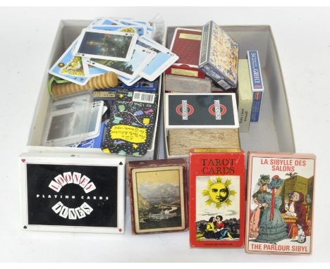 A collection of various playing cards, most being traditional, also including some Tarot