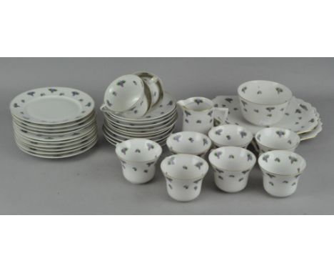 A 'Union K' porcelain part tea set, decorated with grapes, including teacups, saucers, a milk jug and more
