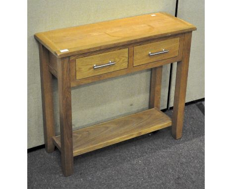 A contemporary oak side table, with frieze drawers and lower tier shelf, all raised on square legs, 76cm high x 85cm wide x 3