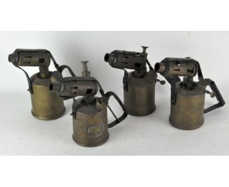 A group of four vintage blow torches