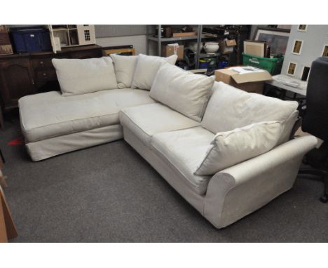 A large two-part corner sofa, with numerous cushions, the largest section approx 205cm long