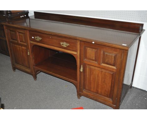 An Edwardian mahogany sideboard with two panel door cupboards flanking a drawer set with brass handles, 91cm high x 204cm wid