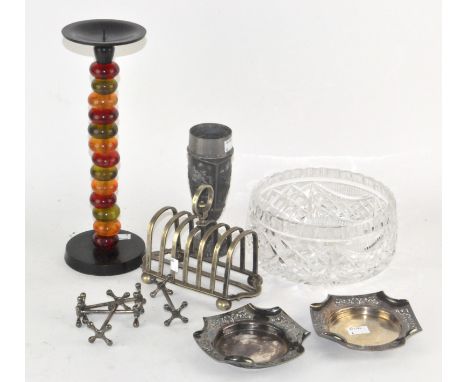 A silver plated six slice toast rack, 18cm wide; together with two dishes, four knife rests, an unusual spirit candlestick an