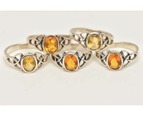 FIVE WHITE METAL GEM SET RINGS, of the same design, each set with an oval cut orange stone, each stamped 925, ring sizes K, O