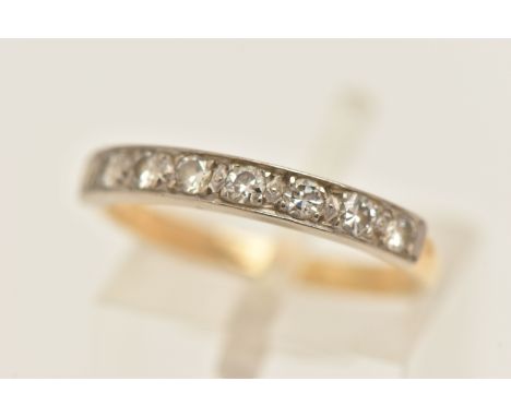 A DIAMOND BAND RING, eight round brilliant cut diamonds, grain set in white metal, leading onto a yellow metal shank, approxi
