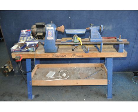 A RECORD POWER MODEL 0 WOODTURNING LATHE mounted to a Record bench with five chisels and gouges and a Record RP3000x chuck se