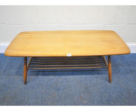 LUCIAN ERCOLANI, AN ERCOL MID CENTURY ELM AND BEECH COFFEE TABLE, raised on cylindrical tapered legs, united by a spindle und