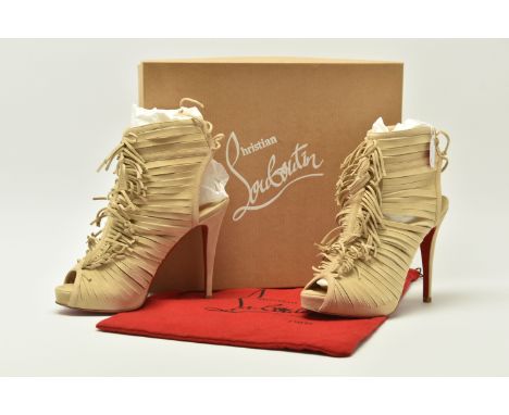 CHRISTIAN LOUBOUTIN : a boxed pair of 'Deva 120 suede' sable coloured suede fringed peep toe sandals, iconic red leather sole