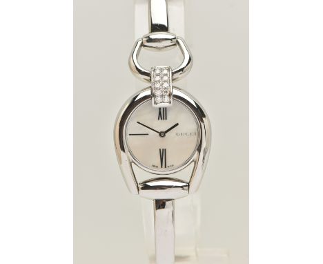 A 'GUCCI' LADIES WRISTWATCH, quartz movement, round mother of pearl dial, signed 'Gucci' at the three o'clock position, Roman