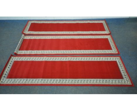 THREE MATCHING RED GROUND SHIRAZ CARPET RUNNERS, with spiral decorative borders, 230cm x 60cm, condition report, all appear u