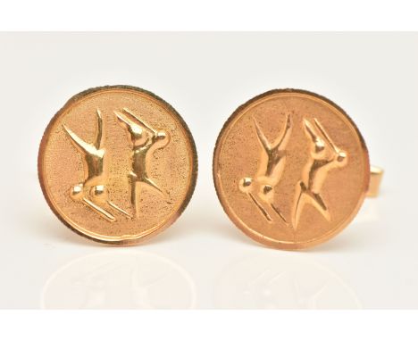 A PAIR OF YELLOW METAL CUFFLINKS, each of a circular form depicting possible figures, to the toggle fittings, unmarked, appro