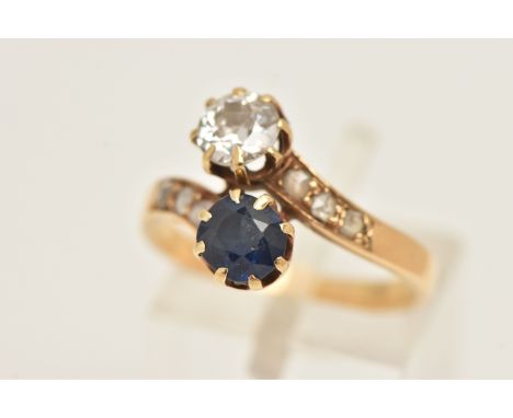 A YELLOW METAL DIAMOND AND SAPPHIRE NORTH AND SOUTH SET RING, claw set with an old cut diamond, measuring approximately 5.4mm