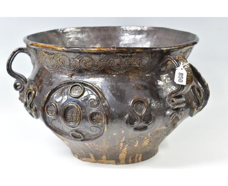 A LARGE GLAZED STONEWARE PLANTER with moulded relief designs in the forms of faces, foliate patterns, etc, sgraffito patterns