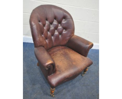 A LEATHER UPHOLSTERED ARMCHAIR, with button back, raised on turned front legs, width 84cm x depth 88cm x height 88cm, conditi