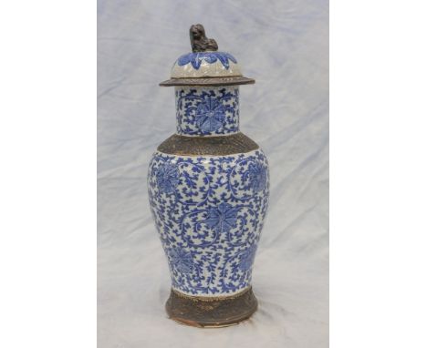 Chinese porcelain lidded jar with blue & white floral decoration, rim, shoulder, & foot with carved dragon black band decorat