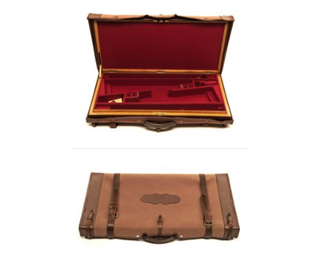 ASPREY AN OAK AND LEATHER DOUBLE GUNCASE, fitted for 28in. side by side barrels, the interior lined with red baize, central b