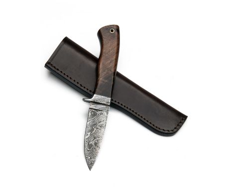 A DAMASCUS CLIP-POINT KNIFE, 3 3/4in. blade, damascus guard, walnut one-piece handle with lanyard hole, in its leather sheath