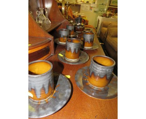 BEDDGELERT POTTERY COFFEE POT, CREAM JUG, SUGAR BOWL,  AND SIX CUPS AND SAUCERS IN AN OCHRE AND METALLIC GLAZE