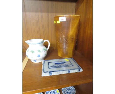 A CERAMIC VASE IN A BROWN GLAZE, A LOWE POTTERY WORKS SALT GLAZED PLAQUE IMPRESSED WITH COW, AND A PORCELAIN JUG WITH ABSTRAC