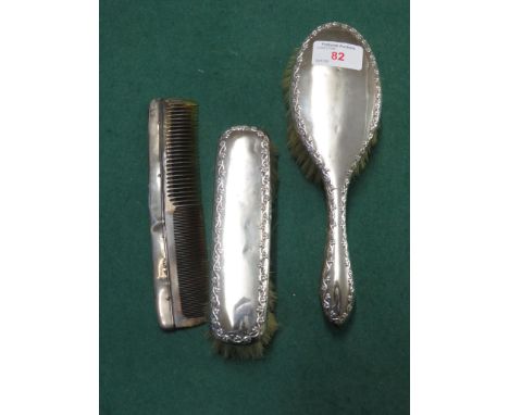 TWO SILVER BACKED DRESSING TABLE BRUSHES MATCHED WITH A SILVER BACKED COMB