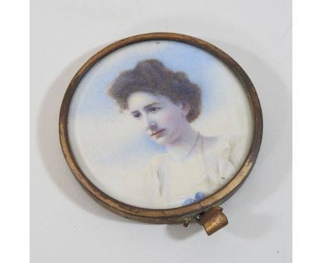 English School, early 20th century, a miniature portrait of Miss Eva Grey, watercolour, 7cm diameter, in a gilt metal frame, 