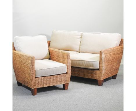 A rattan sofa, with loose cushions, 162cm, together with a matching armchair and occasional table