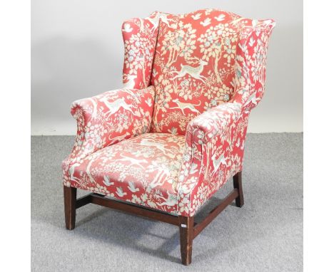 A 19th century floral and animal print upholstered wing back armchair