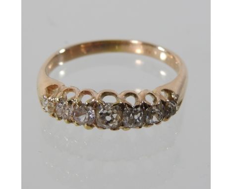 A seven stone diamond half hoop eternity ring, set with a row of graduated stones, approximately 1.0 carats overall